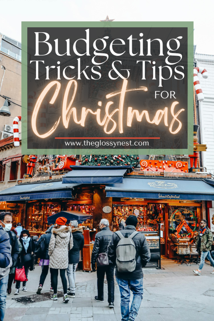 A bustling Christmas market with a large decorated tree, candy cane poles, and festive stalls welcomes visitors. Bundled in winter clothing, they explore the merry scene. Text at the bottom reads "Christmas Budget Planning: Tips to Keep Spending in Check" with a website link.